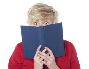 Surprised woman reading a romance novel